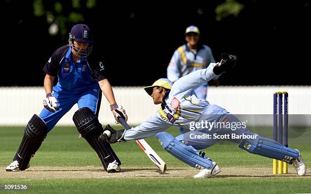 Indian wicketkeeper Anju Jain dives to take the ball as Jane Cassar of England looks on during the England v India match in the 2000 CricInfo Womens...