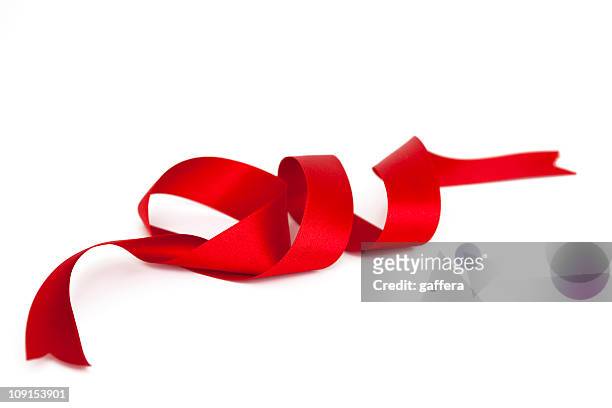 a spiral satin red ribbon with ends cut - satin ribbon stock pictures, royalty-free photos & images