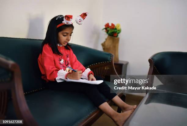 young girl writing a letter to santa claus - child writing letter to santa stock pictures, royalty-free photos & images