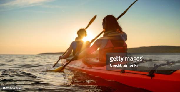 kayaker rowing in sea - kayak stock pictures, royalty-free photos & images