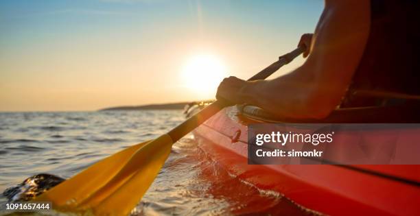 kayaker rowing in sea - oar stock pictures, royalty-free photos & images