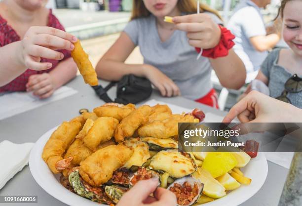 family eating fried fish - fish and chips stock pictures, royalty-free photos & images