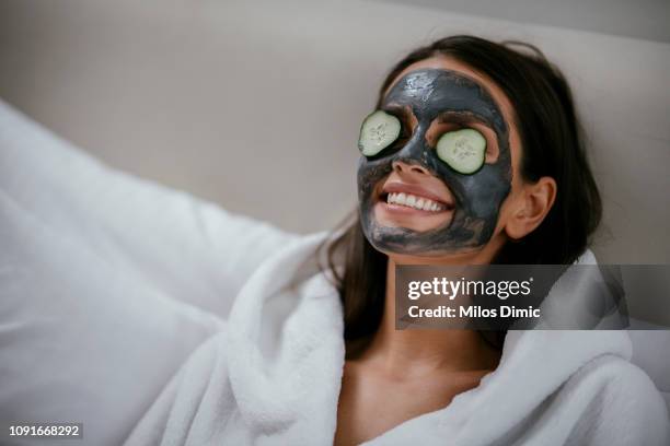 women holding slices of cucumber - mask imagens e fotografias de stock