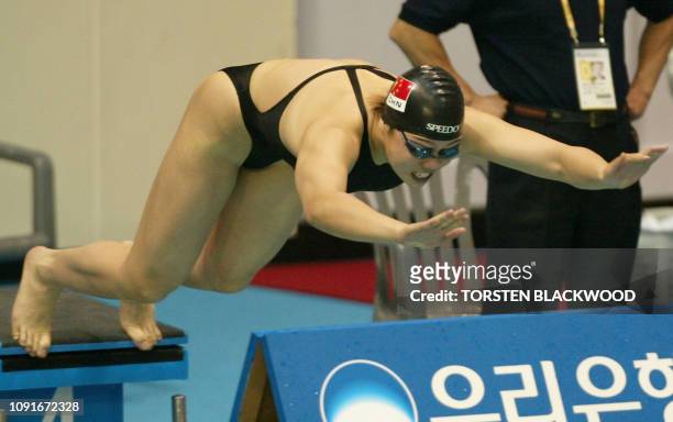 China's Xu Yanwei dives from the block at the start of the women's 50m freestyle heat at the 14th Asian Games in Busan, 04 October 2002. Xu set the...