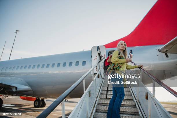 goodbye home, hello world - boarding plane stock pictures, royalty-free photos & images