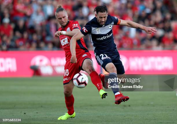 Ken Ilso Larsen of Adelaide United clashes with Carl Valeri of Melbourne Victory during the round 12 A-League match between Adelaide United and the...