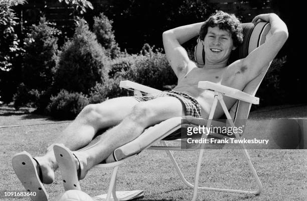 English soccer player Clive Allen sunbathing on a sun lounger, UK, 12th June 1980.