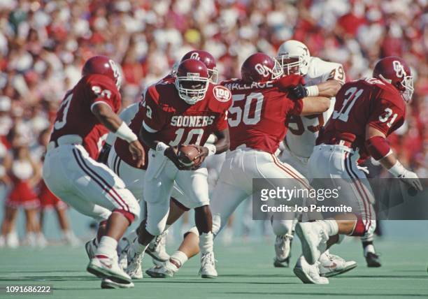 Steve Collins, Quarterback for the University of Oklahoma Sooners prepares to hand the ball off during a NCAA Southwest Conference college football...