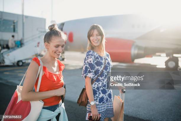 young couple boarding their plane - british culture walking stock pictures, royalty-free photos & images