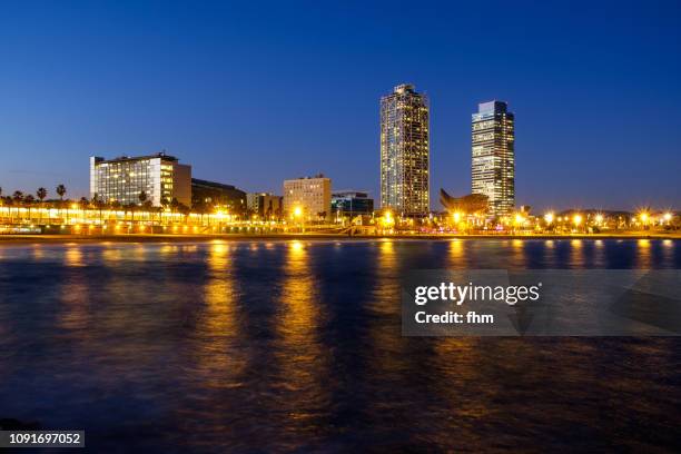 barcelona, spain - blue hour at la barceloneta - barceloneta fotografías e imágenes de stock