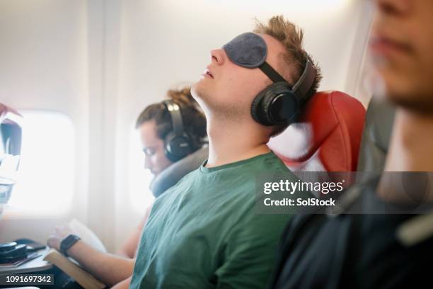 noisy snorer on a flight - plane passenger stock pictures, royalty-free photos & images