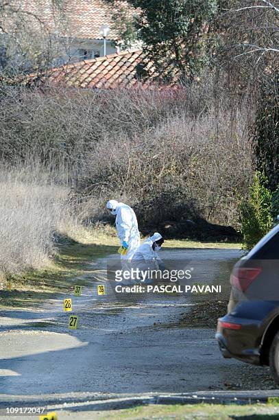 Des experts de la brigade scientifique examinent des traces sur un chemin de la commune de Bouloc, le 15 février 2011, où des effets personnels de...