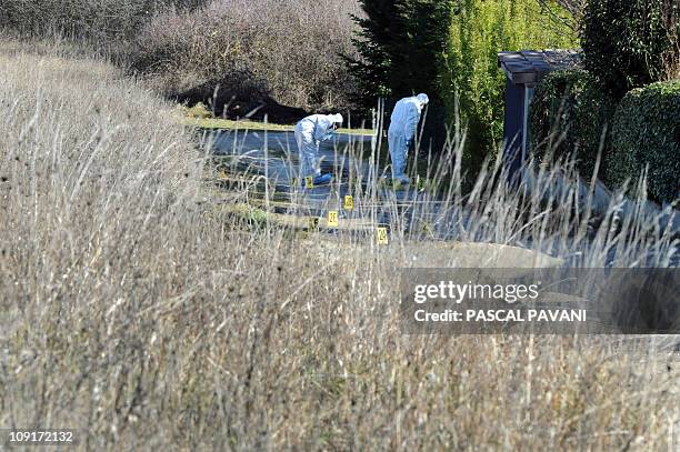 Des experts de la brigade scientifique examinent des traces sur un chemin de la commune de Bouloc, le 15 février 2011, où des effets personnels de...