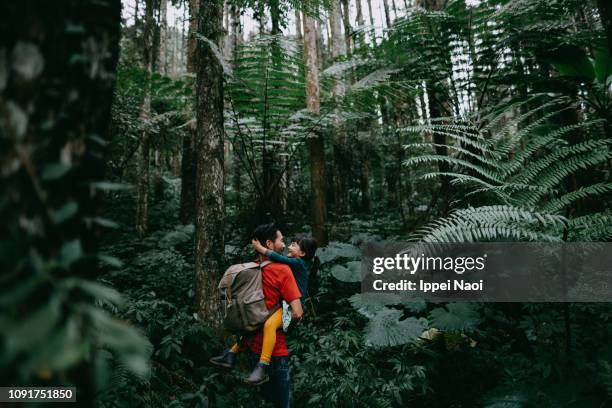 Father and preschool daughter having intimate moment in jungle