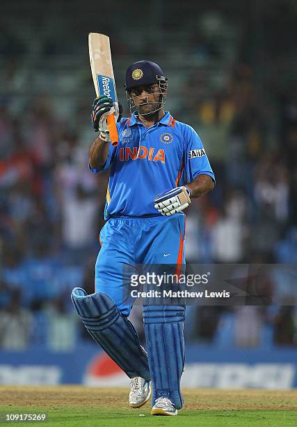 Dhoni of India celebrates his century during the 2011 ICC World Cup Warm up game against India and New Zealand at the MA Chidambaram Stadium on...