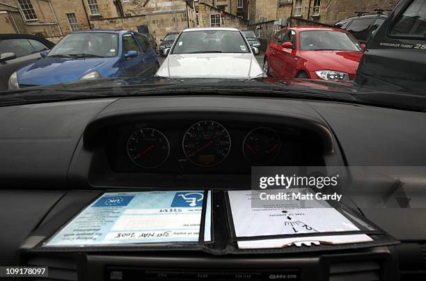 In this photo illustration a disabled badge is displayed on a car dashboard in a car park on February 16, 2011 in Bath, England. The government is...