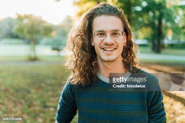 pierced young guy in the park - piercing stock pictures, royalty-free photos & images