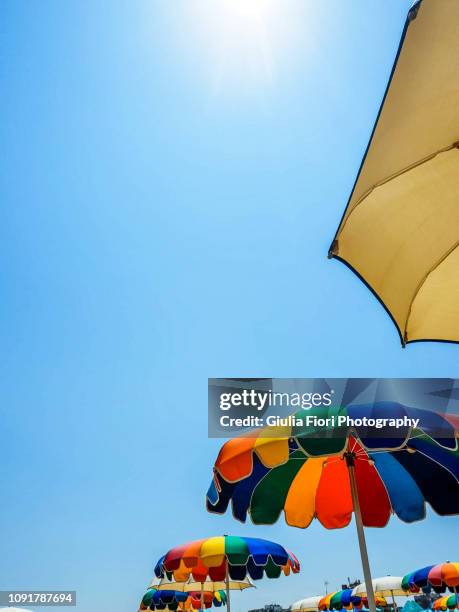 colorful parasols against the blue sky - rimini fotografías e imágenes de stock