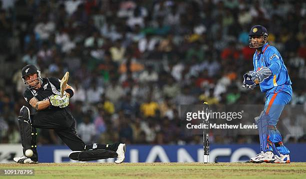 Brendon McCullum of New Zealand pulls the ball towards the boundary, as MS Dhoni of India looks on during the 2011 ICC World Cup Warm up game against...