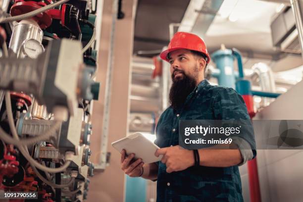 stationary engineer at work - heating engineer stock pictures, royalty-free photos & images