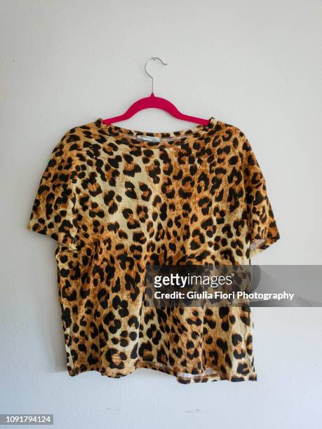 leopard t-shirt on a hanger - leopardenfell stock-fotos und bilder