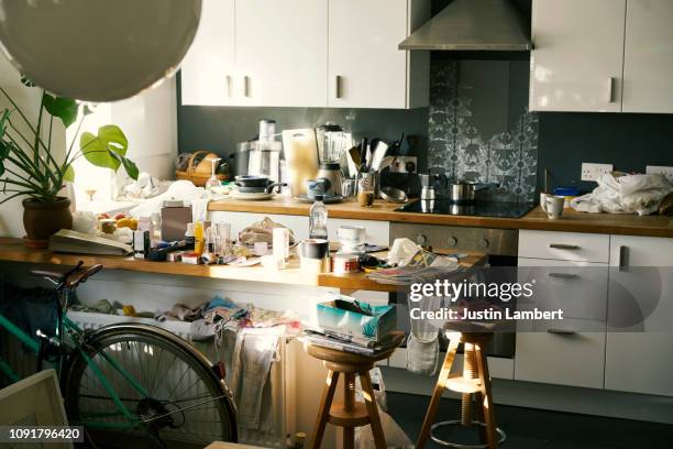 messy apartment counter tops covered in clutter - kitchen stockfoto's en -beelden