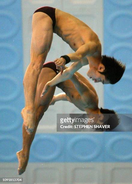 China's Xu Hao and Hu Jia perform in the men's 10m Synchronized Diving event 08 October 2002 at the 14th Asian Games in Busan. China took the gold...