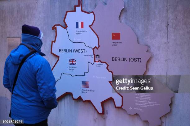 Visitor looks at a map of the Cold War zones of U.S., British, French and Soviet occupation of West and East Berlin at an outdoor exhibit near the...