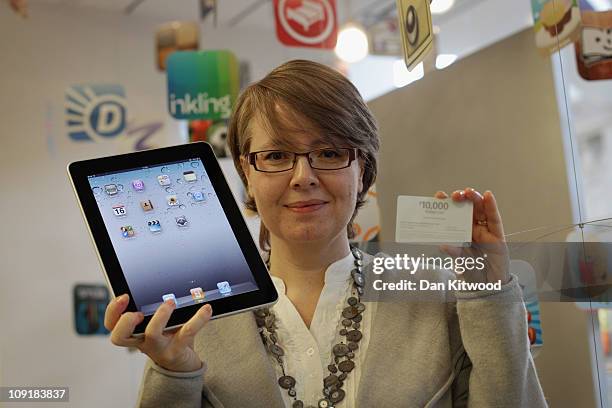 Gail Davis from Orpington in Kent, poses for pictures at the Apple Store in the Bluewater Shopping Centre, after winning the App Store Countdown to...