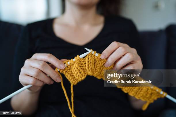 close up on young woman's hands knitting - knitting stock pictures, royalty-free photos & images