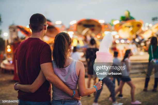 young couple in amusement park - cotton candy stock pictures, royalty-free photos & images