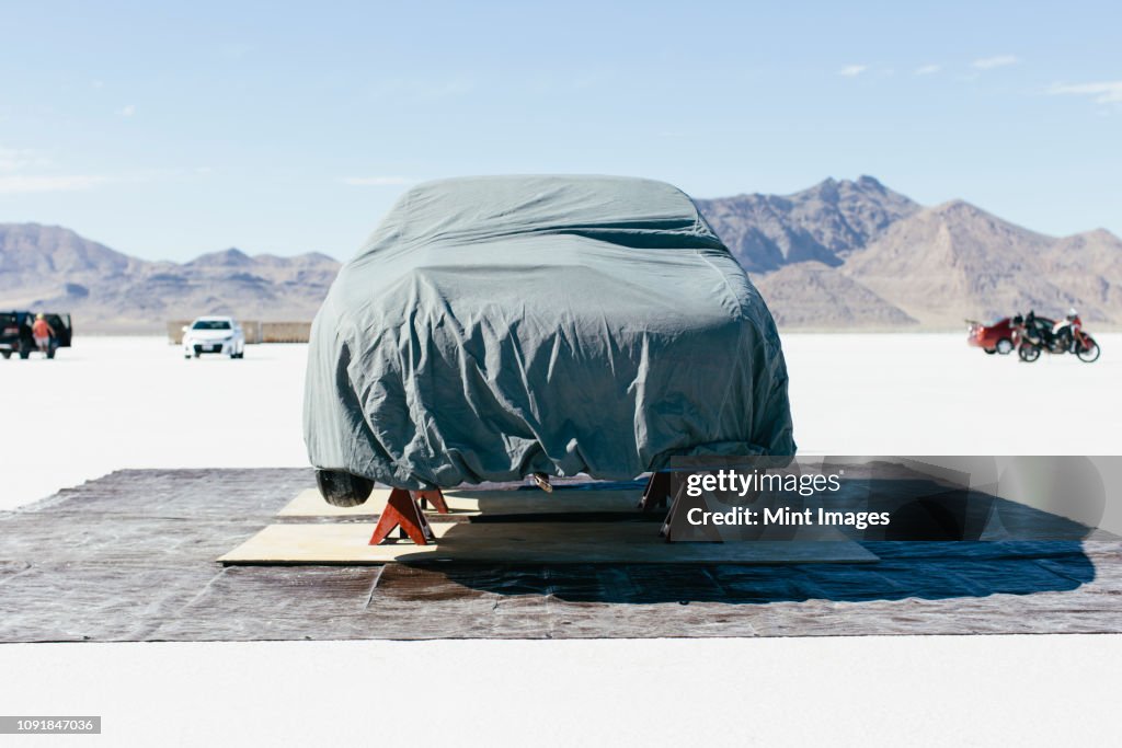 Race car covered with protective cloth in the Salt Flats