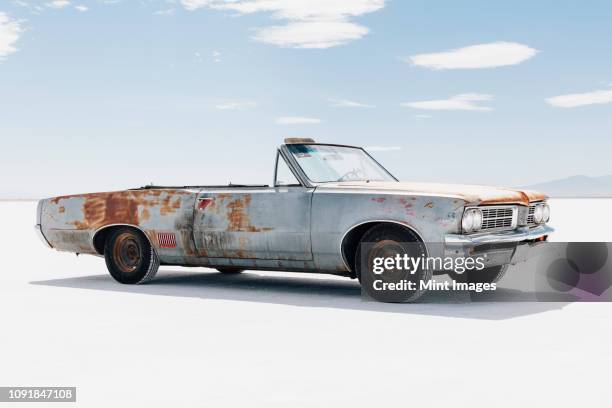 old pontiac convertible parked on salt flats - convertible isolated stock pictures, royalty-free photos & images