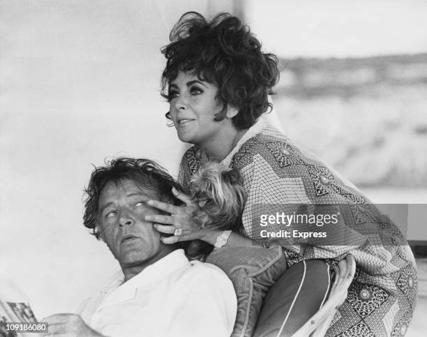 British-born actress Elizabeth Taylor and her husband, Welsh actor Richard Burton on their yacht 'Kalizma' off Capo Caccia on the coast of Sardinia,...