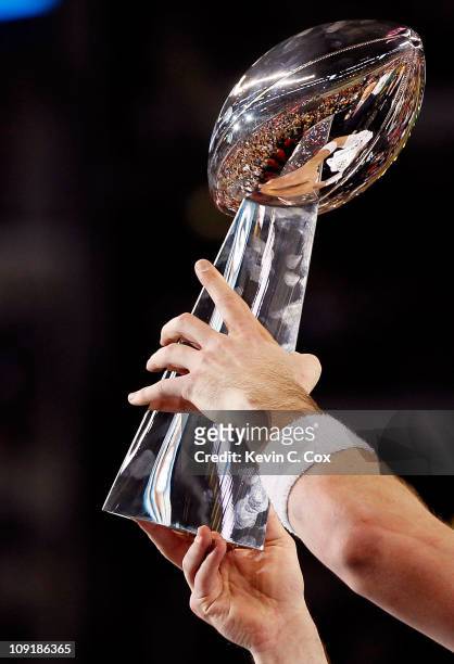 Quarterback Aaron Rodgers of the Green Bay Packers holds up the VInce Lombardi trophy after the Packers won 31-25 against the Pittsburgh Steelers...