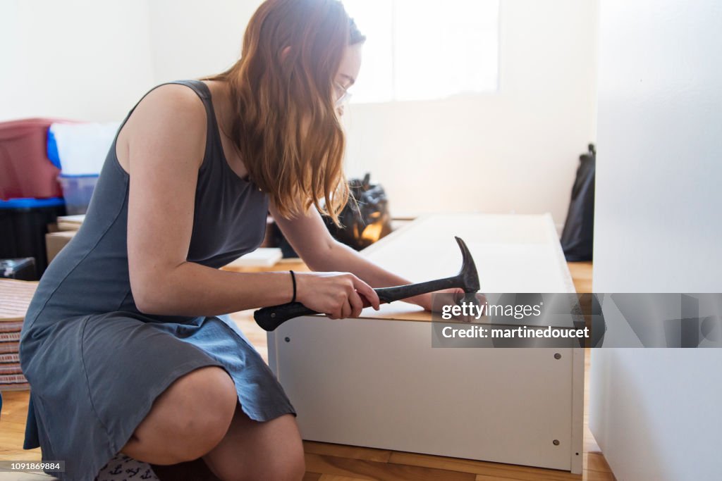 Millennial young woman moving in new apartment.