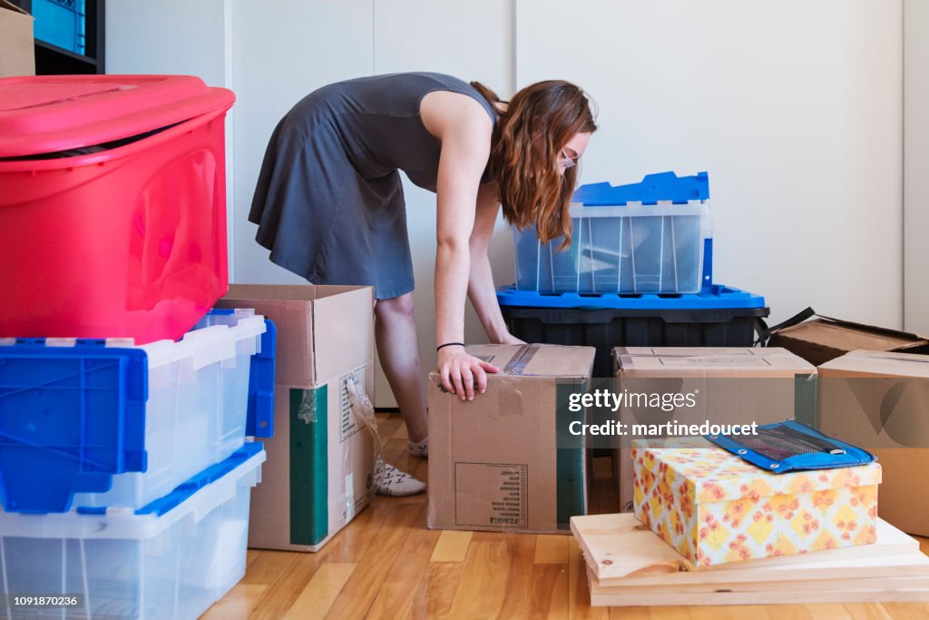 Millennial young woman moving in new apartment.