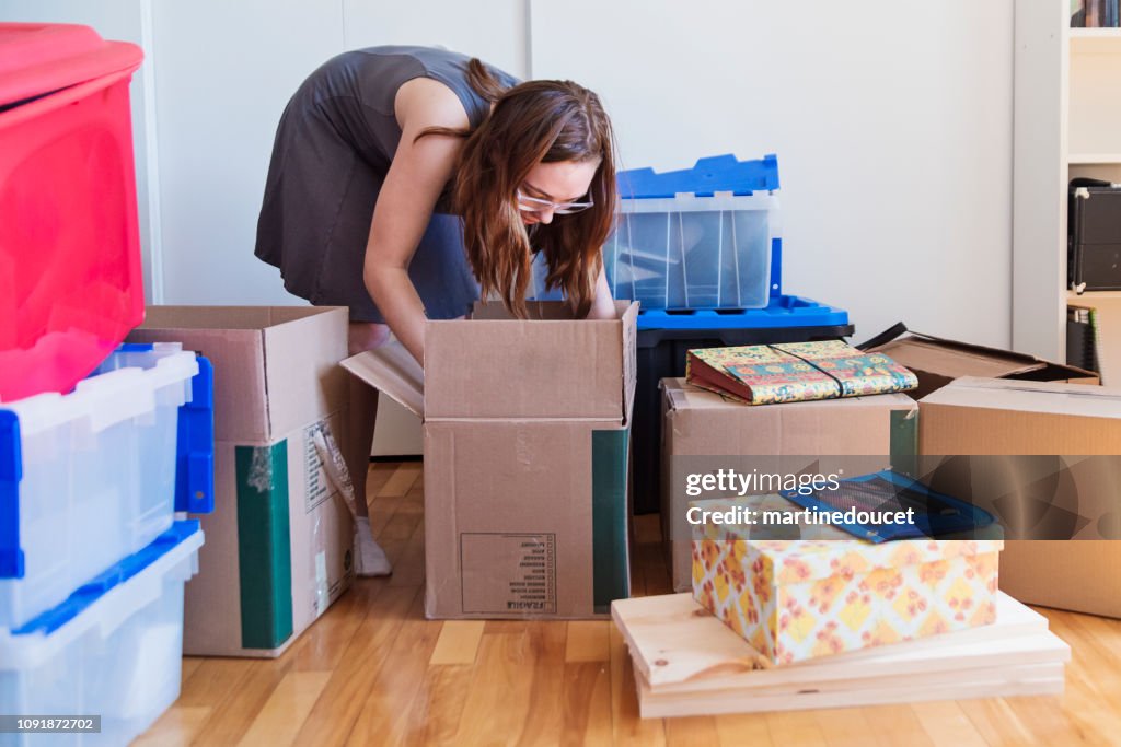 Millennial young woman moving in new apartment.