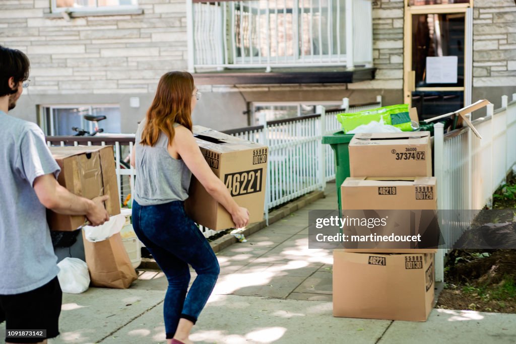 Millennial couple moving in new apartment.