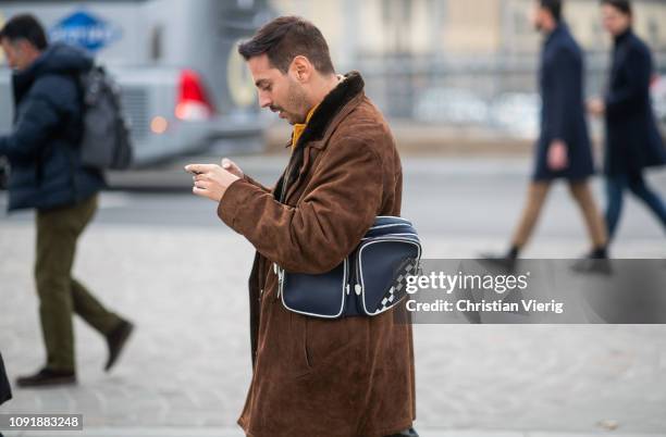 Roberto De Rosa is seen wearing belt bag, brown shearling coat during the 95th Pitti Uomo at Fortezza Da Basso on January 09, 2019 in Florence, Italy.