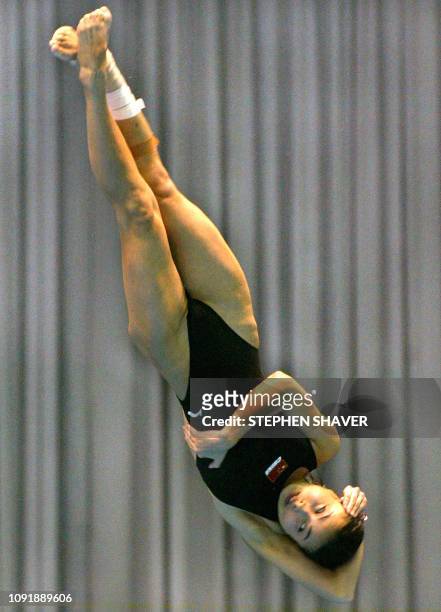 China's Guo Jingjing does a twist during the women's 3-metre springboard final, 10 October 2002 at the 14th Asian Games in Busan. Guo took the gold...