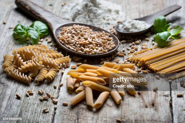 raw spelt pasta - wholegrain stock pictures, royalty-free photos & images