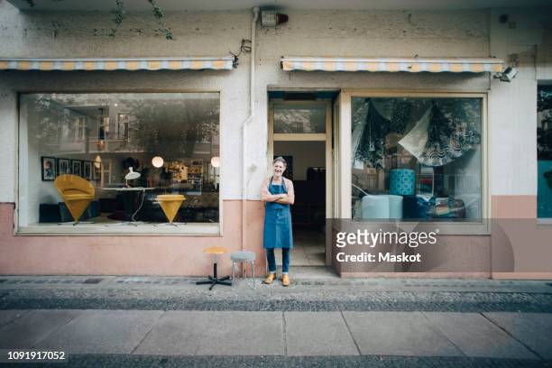 Portrait of confident male upholstery worker standing at workshop entrance