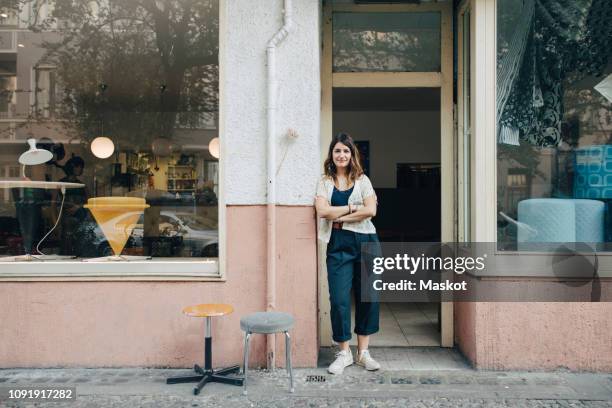portrait of confident female craftsperson standing at workshop entrance - woman standing in doorway stock pictures, royalty-free photos & images