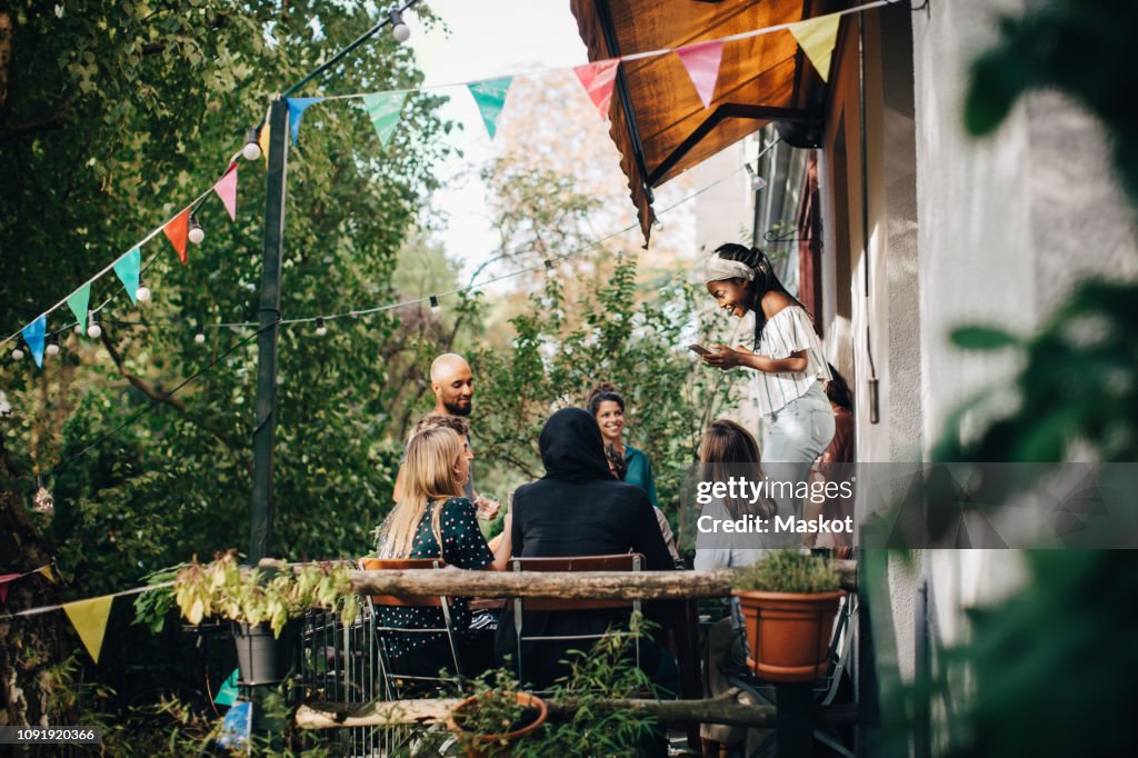 Multi-ethnic young friends enjoying in balcony during party