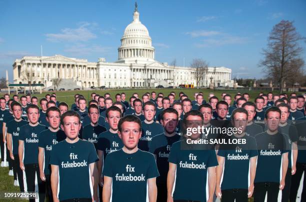 In this file photo taken on April 10 one hundred cardboard cutouts of Facebook founder and CEO Mark Zuckerberg stand outside the US Capitol in...