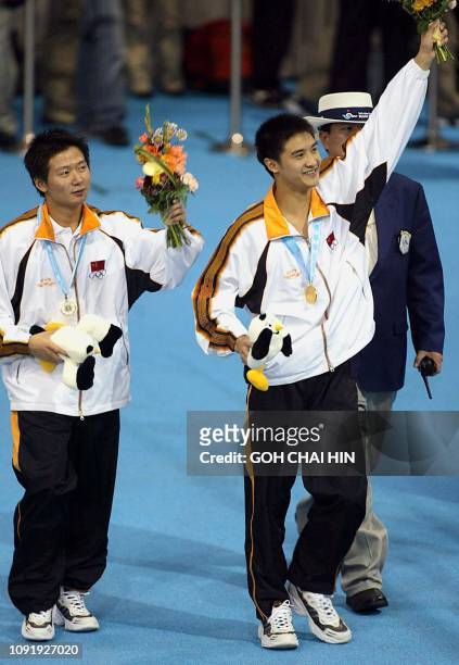 China's Olympic and world champion Tian Liang and teammate Xu Xiang celebrate after receiving their medals in the men's 10m platform final at the...