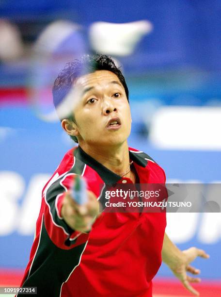 Indonesia's Taufik Hidayat returns the shuttlecock against South Korea's Lee Hyun-Il during the men's badminton singles final at the 14th Asian Games...