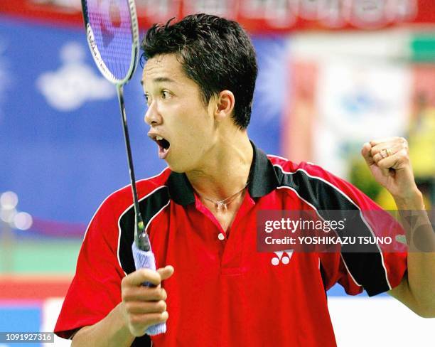 Indonesia's Taufik Hidayat clinches his fist to celebrate his win over South Korea's Lee Hyun-Il in the men's badminton singles final at the 14th...