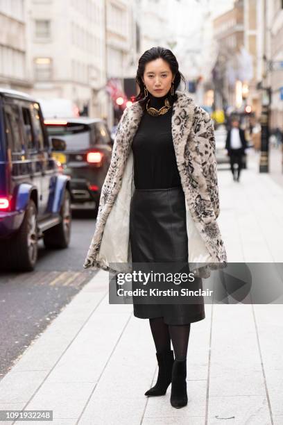 Model and Actress Betty Bachz wears a leopard print faux fur coat with a leather skirt and black boots during London Fashion Week Men's January 2019...